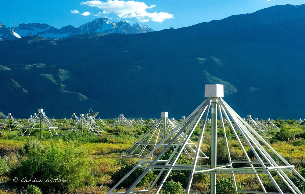 OVRO-LWA radio antenna array with mountains in the background.